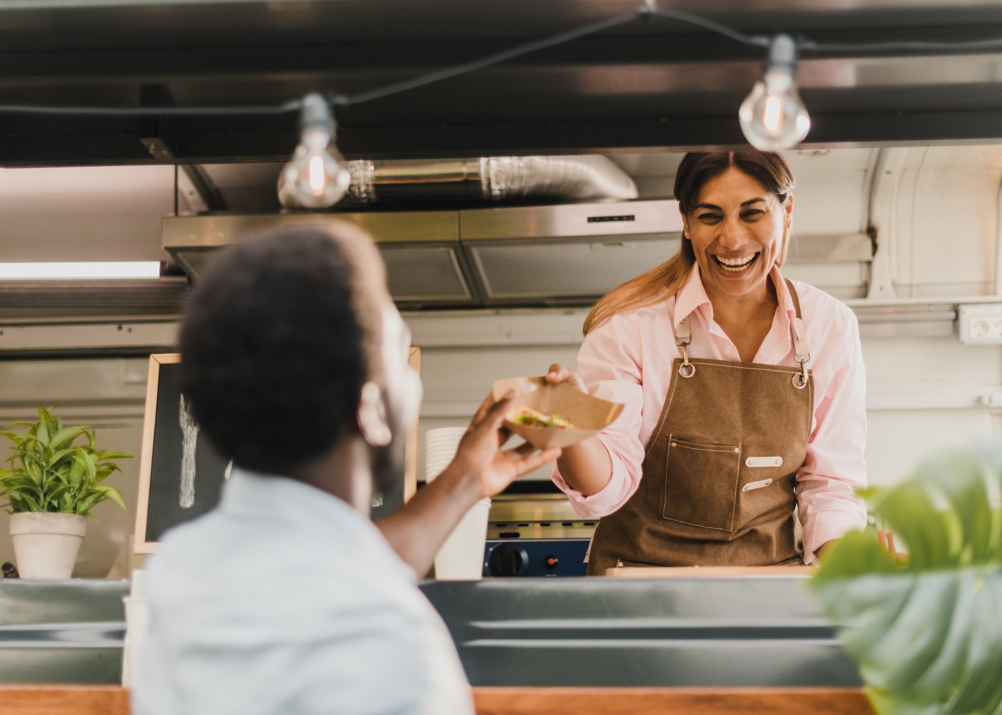 Small Business Owner Serving a Customer